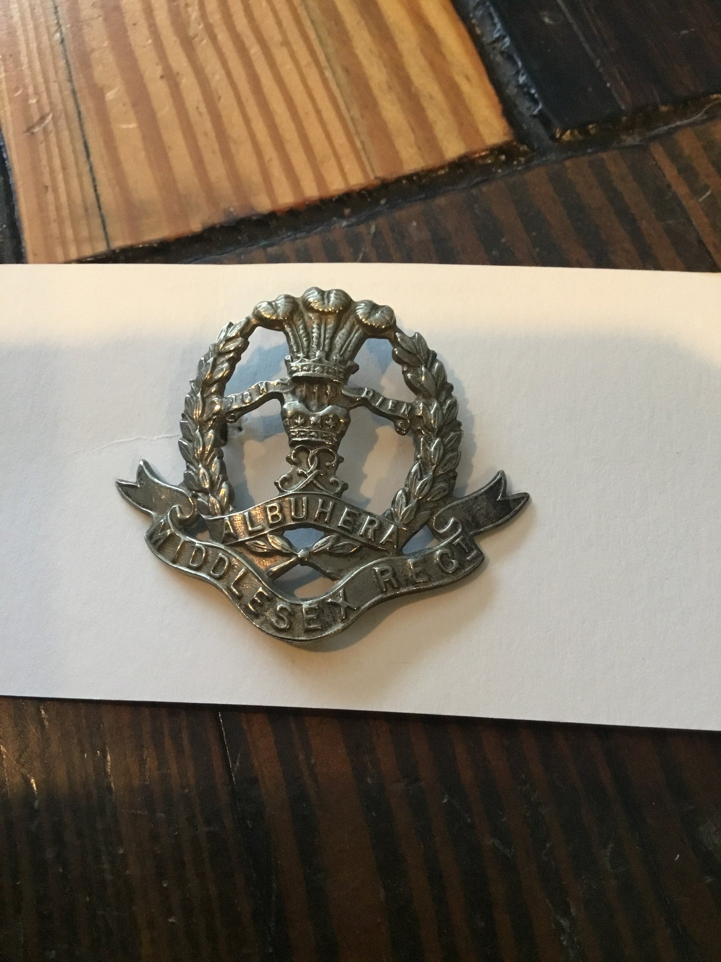 BRITISH, MIDDLESEX REGIMENT CAP BADGE. With lugs