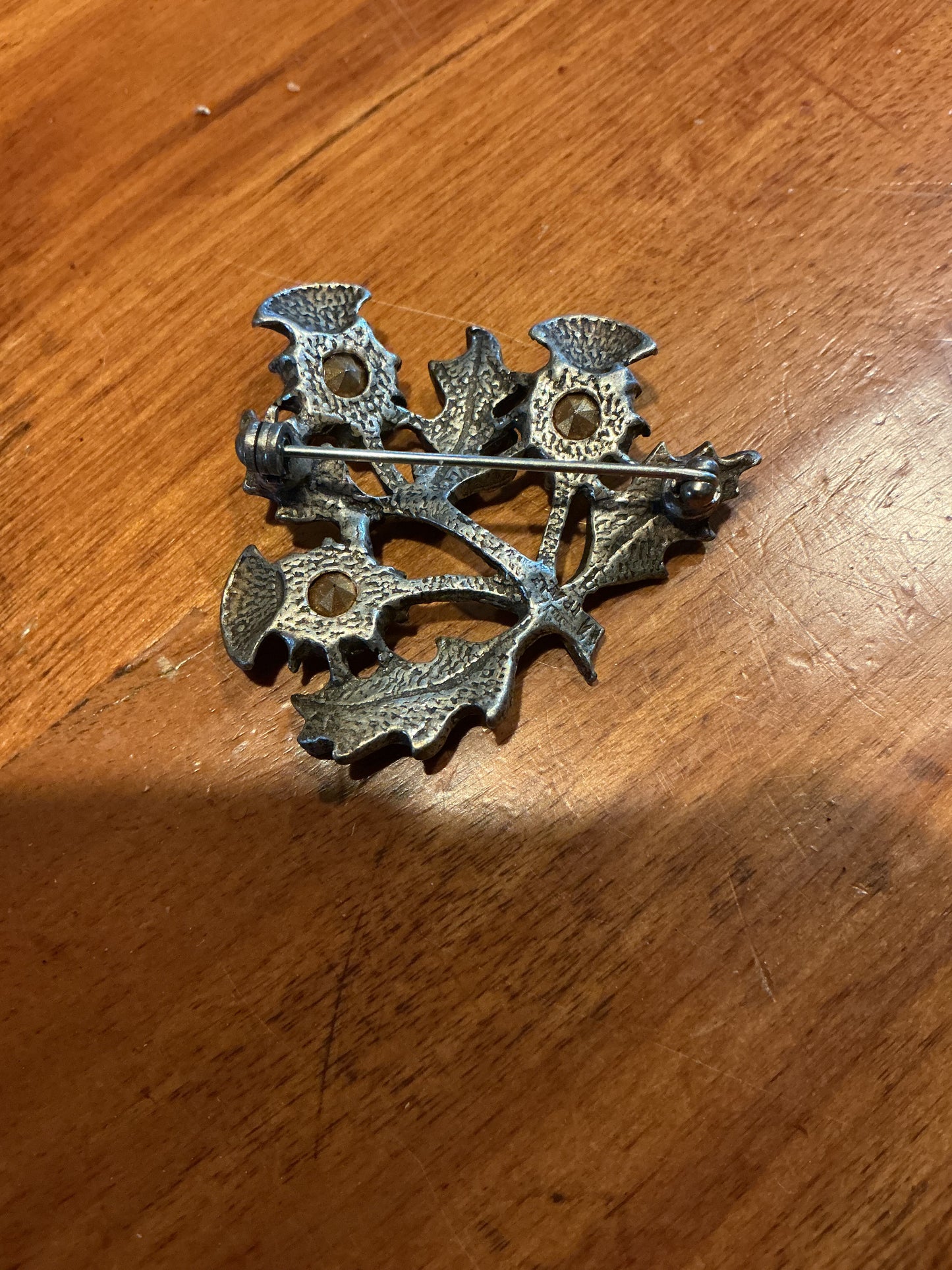 Thistle Kilt Pin/Broach with amethyst type stones .