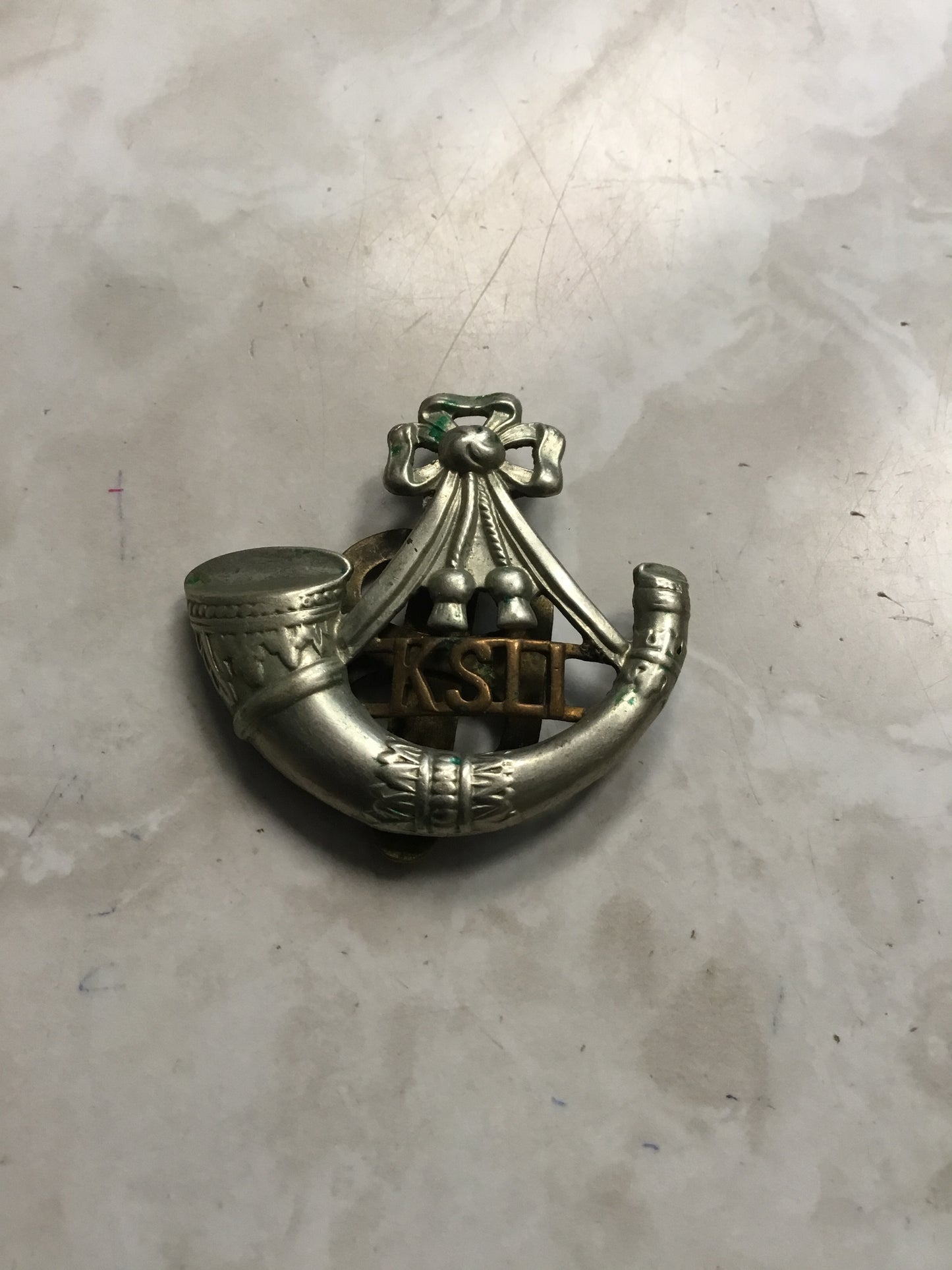 British: King's Shropshire Light Infantry Cap Badge. Bi metal, with slider .