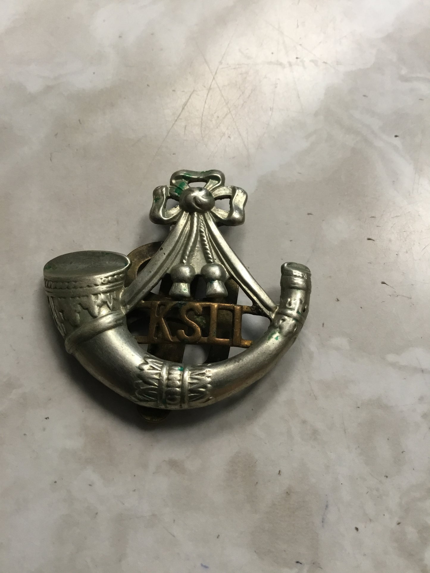 British: King's Shropshire Light Infantry Cap Badge. Bi metal, with slider .