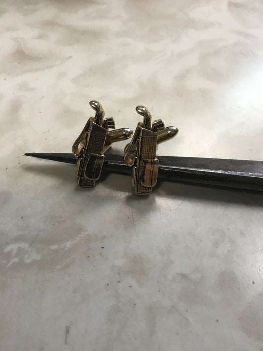 pair of vintage Swank cufflinks in the shape of a golf bag with golf clubs.