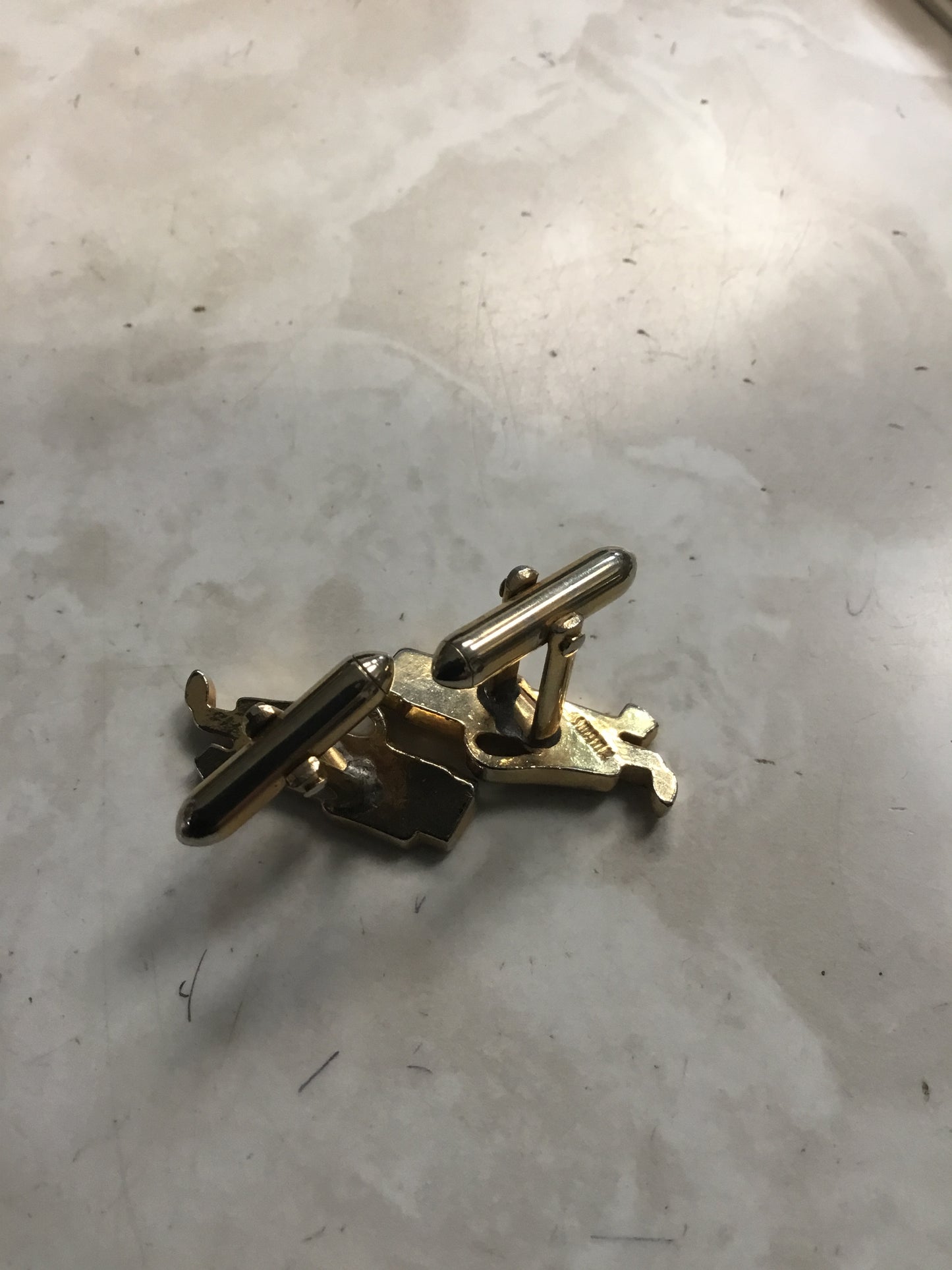 pair of vintage Swank cufflinks in the shape of a golf bag with golf clubs.