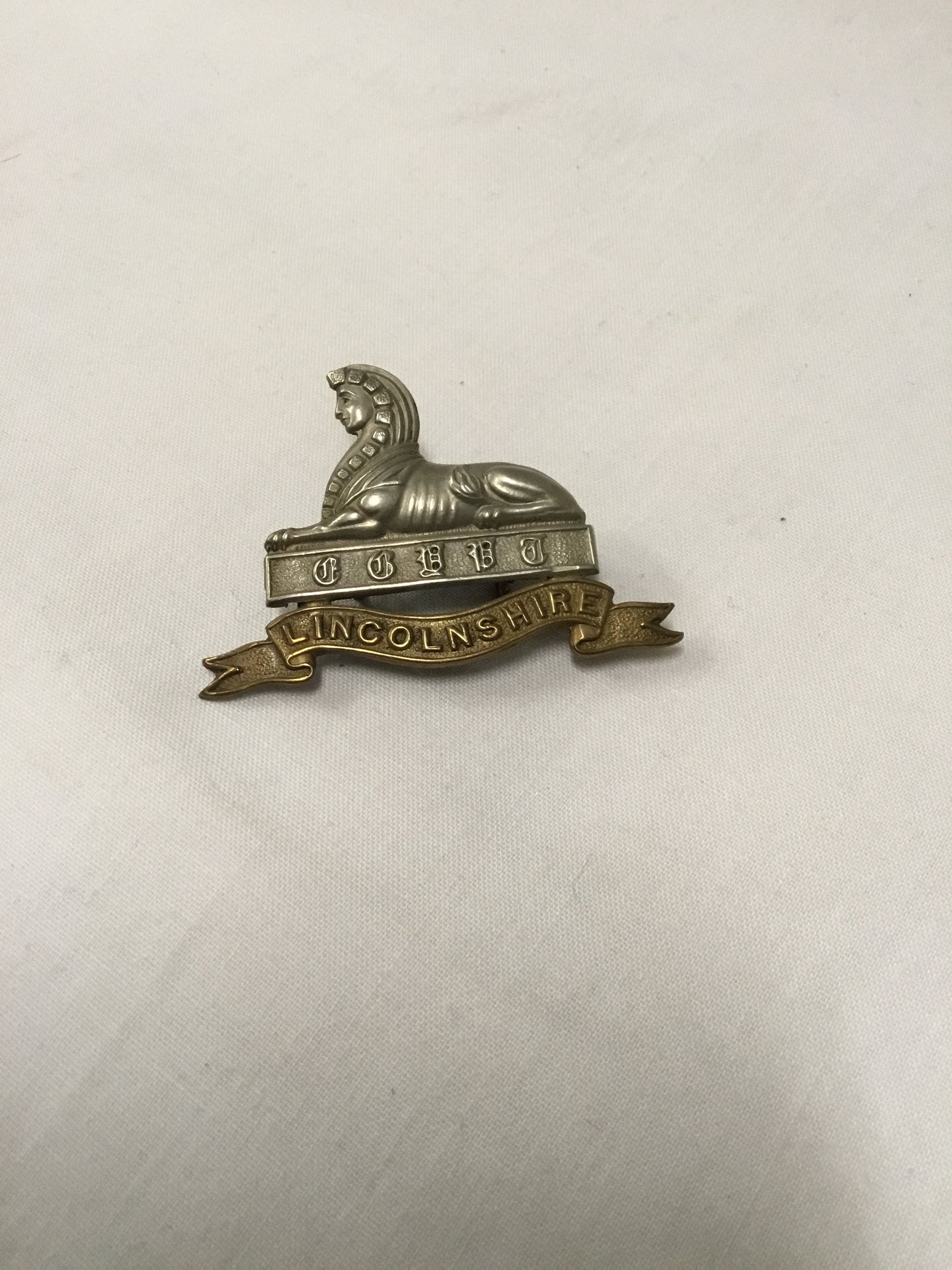 British Army, Lincolnshire Regiment Cap Badge. Bi-metal. Slider on the back