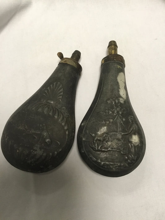 2 Vintage powder flasks with hunting theme .